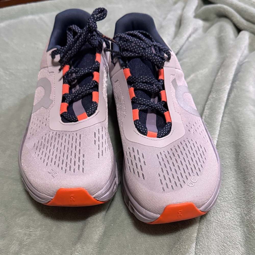 Men’s OnCloud Athletic Shoes with Orange, Navy and Purple Accents.